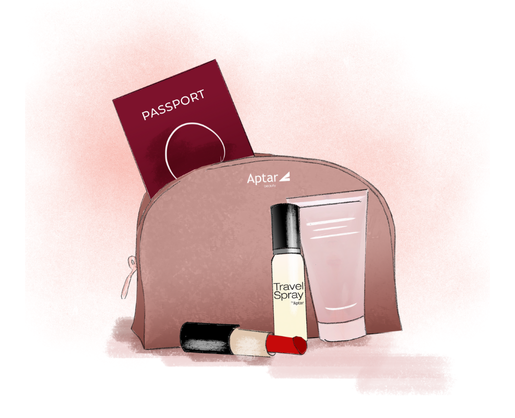 A pink toiletry bag labeled Aptar contains a red passport, a tube of cream, a Mini Spray Packaging named Travel Spray, and a lipstick, all arranged on a soft pink background.