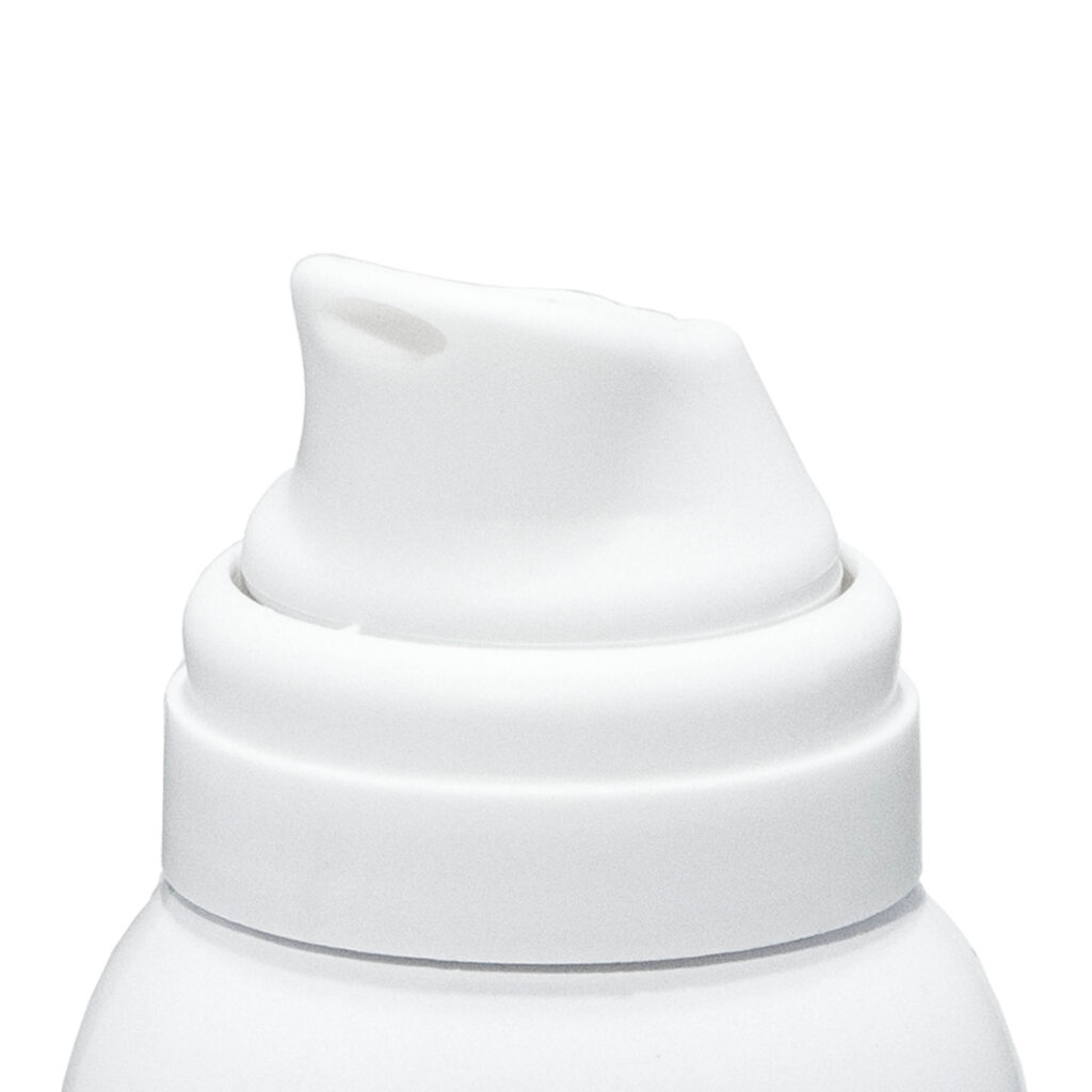 Close-up of Meridian, a contemporary aerosol actuator molded in white on tope of an aerosol can, shown against a plain white background. The nozzle is slightly angled, ready for dispensing liquid or foam product.