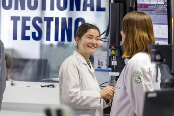 Two Aptar Lab Technicians talking in the testing lab
