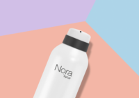 A white aerosol can labeled Nora, a twist-to-lock aerosol actuator for gel, rests on a background with pastel pink, purple, and blue geometric shapes.