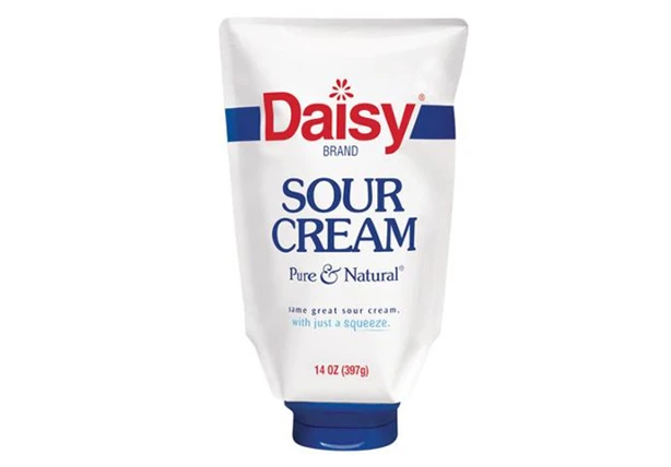 A packshot of Daisy Sour Cream featuring one of Aptar's innovative custom clusre
