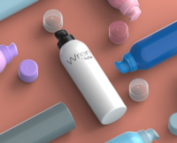 A white bottle labeled 'WREN by Aptar' with a black aerosol actuator for mousse and lotion lies on a soft peach surface. Surrounding it are various colorful bottles each equipped with an actuators and clear plastic caps.