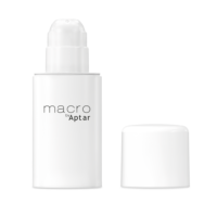 A white plastic airless bottle labeled Macro by Aptar, which is a bottom fill airless packaging, stands upright with its matching white cap placed beside it on a plain white background.
