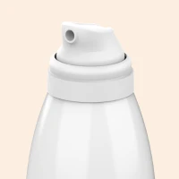 Close up of Aptar Beauty Meridian Aerosol Mousse Actuator White Finish on Beige Background