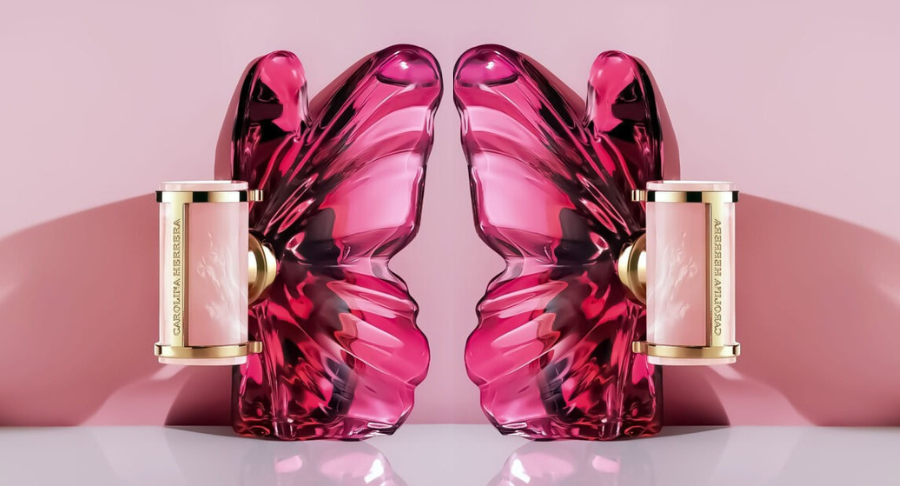 Two butterfly-shaped Carolina Herrera La Bomba fragrances back-to-back on pink background
