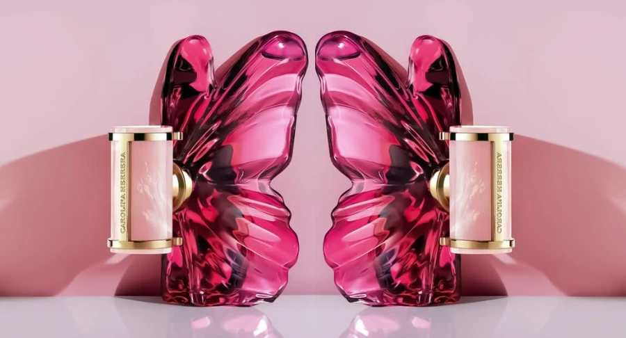 Two butterfly-shaped Carolina Herrera La Bomba fragrances back-to-back on pink background