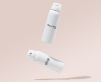 Aptar Beauty’s Apollo Dual-Spray aerosol actuator and Glide aerosol actuators appear to float side by side against a light beige background. The Apollo actuator is shown with a sleek cap in place, while the Glide actuator is uncapped, revealing its dispensing nozzle.