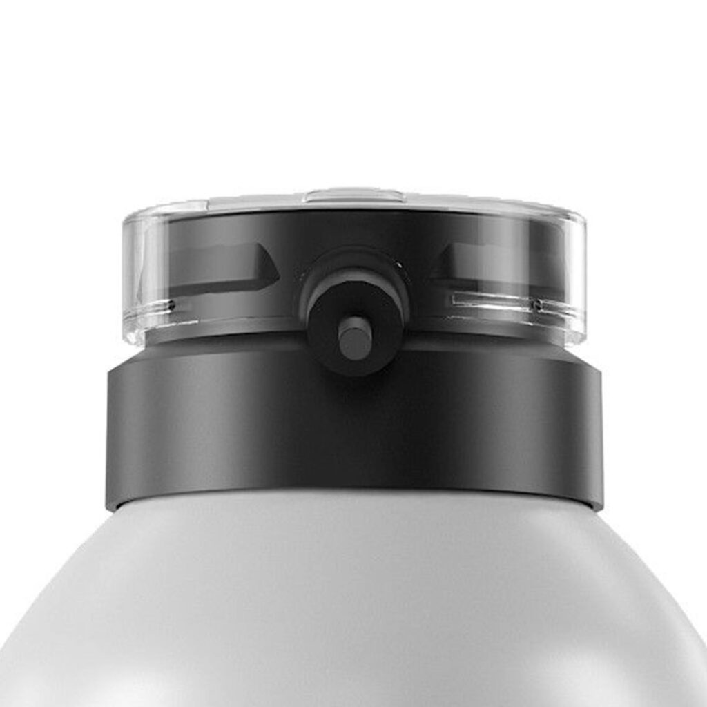 Close-up of an ergonomic aerosol actuator named S7 attached to the top of a matte gray bottle.