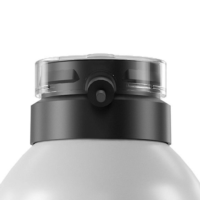 Close-up of an ergonomic aerosol actuator named S7 attached to the top of a matte gray bottle.