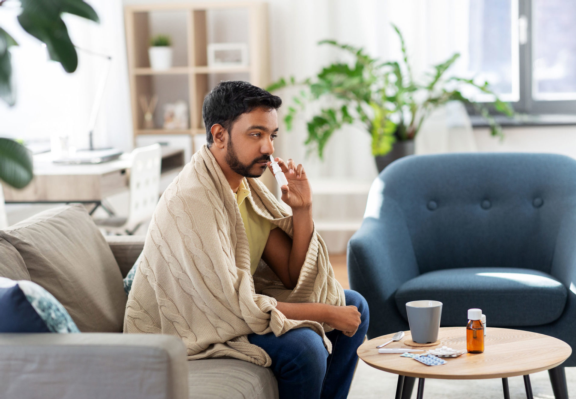 Man-using-aptar-pharma-nasal-spray-pump-scaled-1920x1330.jpg