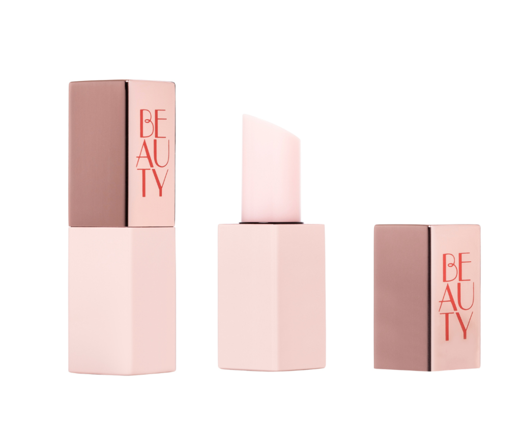 A pink and rose gold guided mini lipstick packaging labeled BEAUTY in red letters, shown with the cap on, cap off to reveal the pale pink lipstick, and the cap placed separately.