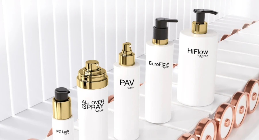 Five white packaging with metal effects golden dispensing systems and decorations standing on a conveyor belt on a white background