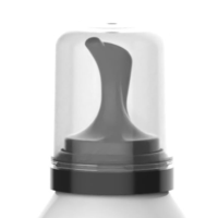 Close-up of a black and gray inverted aerosol actuator with a clear plastic cap, attached to a white bottle, isolated on a white background.