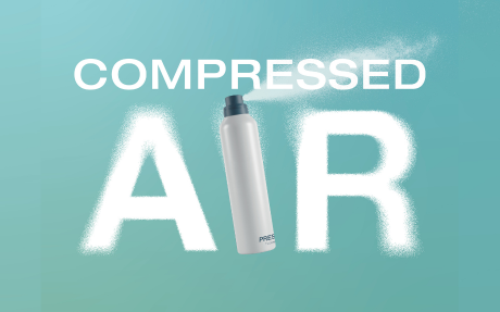 A spray can labeled PRESSAIR, featuring an aerosol valve, releases a white mist to form the words COMPRESSED AIR against a blue background. The mist highlights the word AIR in large, bold letters, showcasing Aerosol Compressed Air.
