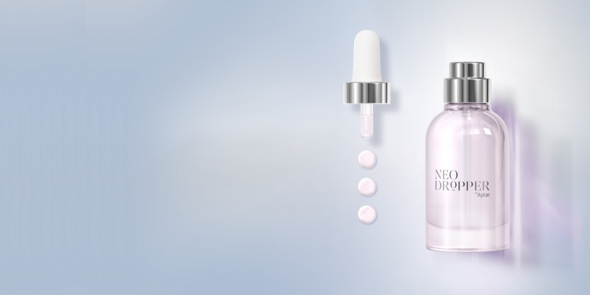 A clear glass bottle with dropper packaging labeled NEO DROPPER by Aptar stands next to a dropper releasing three pink drops, set against a light, soft gradient background.