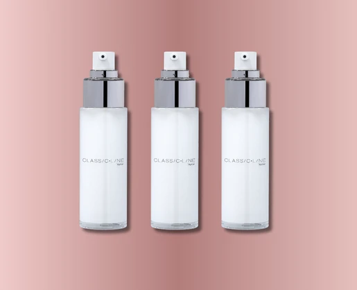 Three identical white timeless and classic cosmetic pump, labeled CLASSICLINE, are arranged in a row against a pink gradient background.