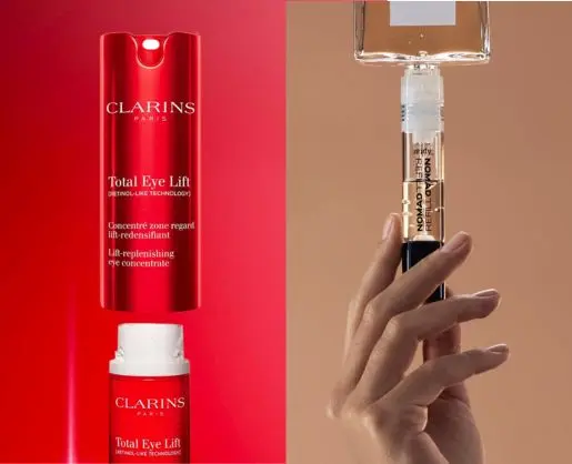 ed Clarins Total Eye Lift container displayed beside a hand holding a transparent refill cartridge connected to an inverted glass bottle against contrasting red and beige backgrounds.