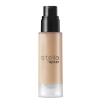 A cylindrical bottle labeled STELLA by Aptar, containing a beige liquid,likely foundation is shown with a versatile airless dispenser. The packaging features a clear base and a frosted body.