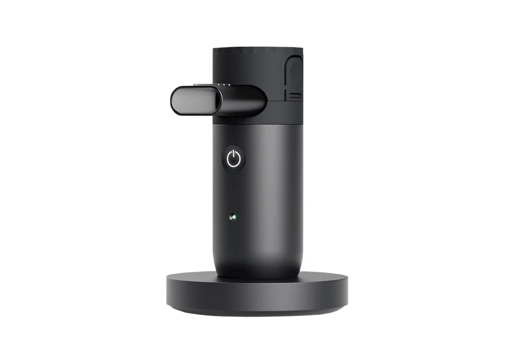Single black cylindrical Kolibri mesh nebulizer (NPLI) on charging mount with digital data connectivity by Aptar.