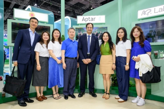 A group of Aptar Employees posing for a picture at a tradeshow in China
