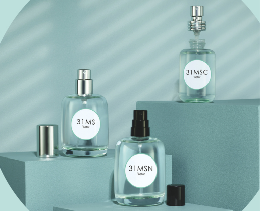 Three glass bottles labeled 31MS are displayed on blue geometric platforms. Each bottle features a lifestyle fragrance pump, with two pumps shown uncapped and their matching caps placed beside them. One pump is removed from its bottle and positioned on top of it.