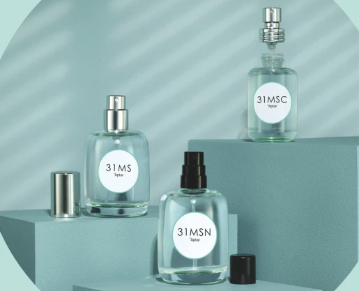 Three glass bottles labeled 31MS are displayed on blue geometric platforms. Each bottle features a lifestyle fragrance pump, with two pumps shown uncapped and their matching caps placed beside them. One pump is removed from its bottle and positioned on top of it.