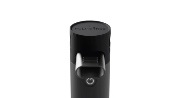 Top view of black cylindrical Kolibri soft mist inhaler (SMI) showing oval inhalation mouthpiece for lung delivery.