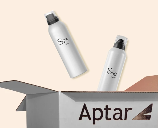Two white spray bottles labeled S30 and S25, featuring an actuator for gel and foam, float above an open Aptar-branded cardboard box, set against a light beige background.