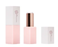 Aptar Beauty's non-guided lipstick model L1727 is showcased in two versions, both featuring a delicate rose motif on the cap: one with the cap closed, and the other with the cap removed and placed beside the base, revealing the pink lipstick bullet