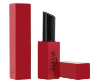 Two red lipstick tubes are shown; one is closed while the other is open, revealing a black lipstick bullet. The tubes are rectangular, and the word BAZAAR is printed on the open tube.
