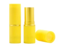 Two yellow lipstick tubes with gold accents are shown on a white background. One tube is closed, one is open revealing the lipstick, and the cap of the open tube is placed beside it.