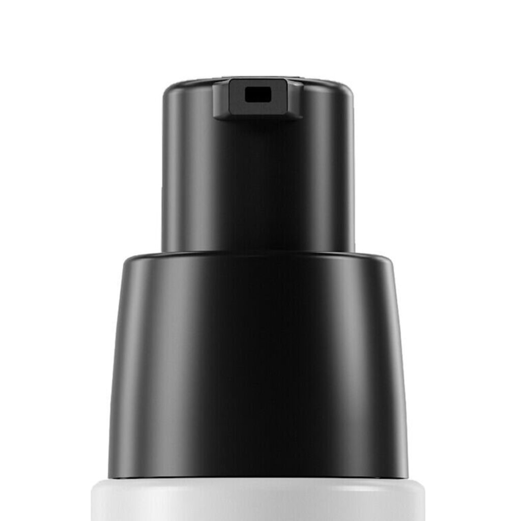 Close-up of PAV/U, a black low dose twist-to-lock cosmetic pump dispenser on top of a white bottle, photographed against a plain white background.