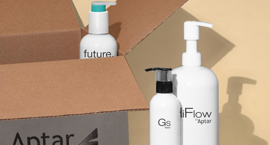 Three white bottles labeled Future, HiFlow, and GS, with GS showcasing Aptar Beauty's Iconic high-performing dispensing pump. Displayed beside an open cardboard box on a soft beige background.