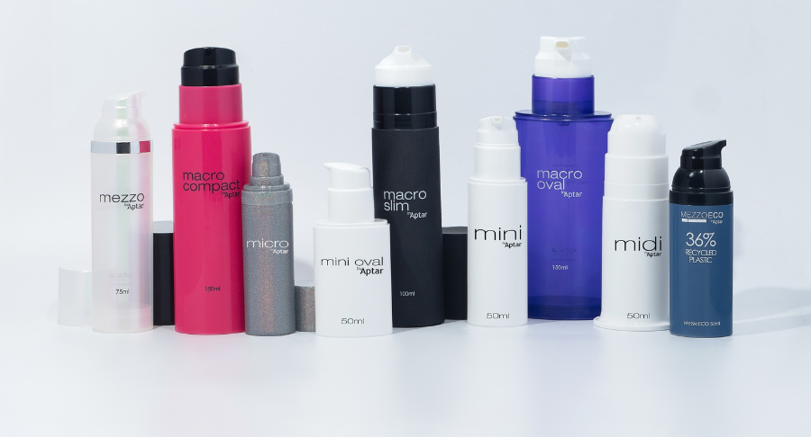 A variety of skincare or cosmetic pump bottles and containers, including airless packaging for high-viscosity formulas named Midi, are arranged in a row on a white background. Each bottle is labeled with product names and capacities.