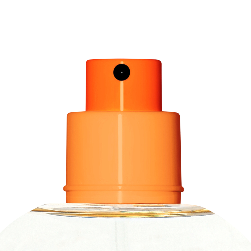 Close-up of an orange plastic fragrance pump named Color Code against a white background, highlighting the top part and spray mechanism.
