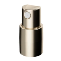 A close-up of the actuator component of PAV, a metallic gold customizable spray pump, shown upright against a plain white background. The actuator is topped with a circular button designed to dispense liquid or mist.