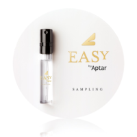 A small transparent perfume sample spray vial is attached to a round white card with gold and black text that reads Easy by Aptar.