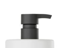 Close-up of a black plastic pump dispenser on top of a white bottle, typically used for liquid soap or lotion.