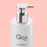 Aptar Beauty's GSA Lotion Pump on a pink background, highlighting it's chrome actuator for a premium finish.