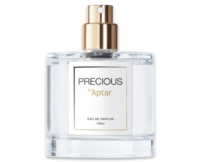 A clear glass refillable fragrance purse spray labeled "Precious by Aptar Eau de Parfum 100 ml", featuring a gold nozzle and an elegant white and gold label. The product, named Precious Sensea, incorporates a sensorial prestige fragrance pump for luxurious and portable fragrance application.