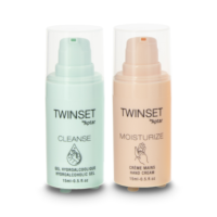 Two small pump bottles labeled TWINSET by Aptar are shown, featuring innovative 2-in-1 Airless Packaging. One is light blue and labeled Cleanse, the other peach and labeled Moisturize. Both have clear plastic caps.