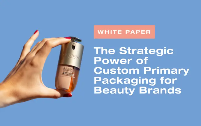 A woman's hand with red nailpolish holds a custom packaging Double Serum Foundation by Clarins as an Illustration of Aptar Beauty's White Paper on Custom Beauty Primary Packaging