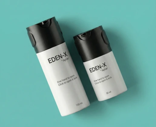 Two EDEN-X white bottles with black actuators sit on a teal background. These lockable, versatile airless packaging solutions come in 100 ml and 50 ml sizes, featuring 