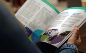 Individual reading a sustainbility report which includes the platinum rating from EcoVadis.