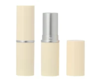 The components of a cream-colored non-guided lipstick packaging with silver accents one version closed, one open showing the silver interior, and one with the cap removed and placed beside it. 