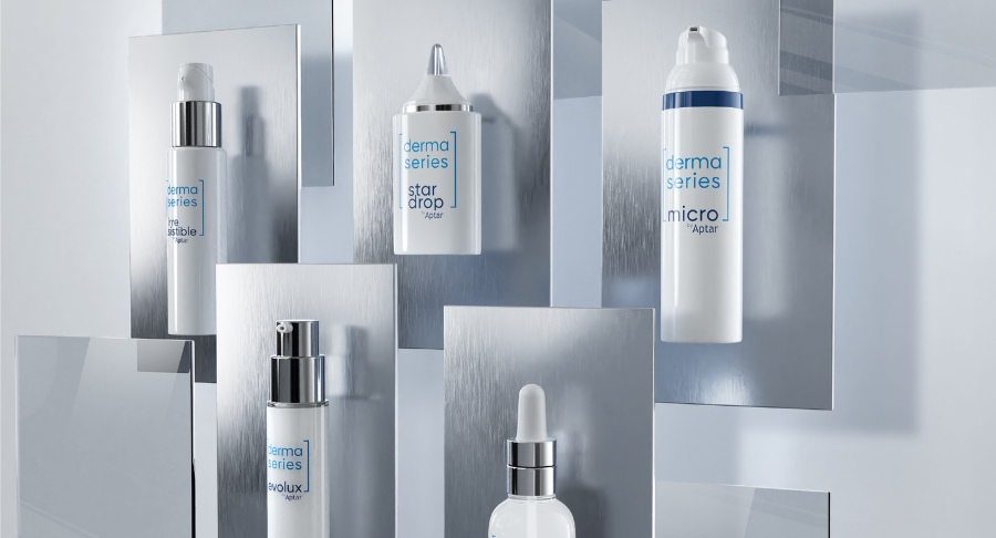 Five sleek white skincare product bottles labeled "derma series" and "star drop" showcase innovative packaging solutions for dermocosmetics, arranged vertically on reflective silver panels against a light grey background. Some bottles have droppers, pumps, or nozzles.



