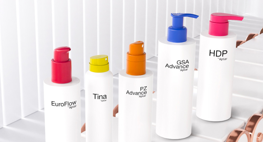 Five white packaging with surface effects colorful dispensing systems standing on a conveyor belt on a white background