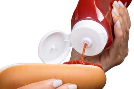 Valve dispensing ketchup on hot dog
