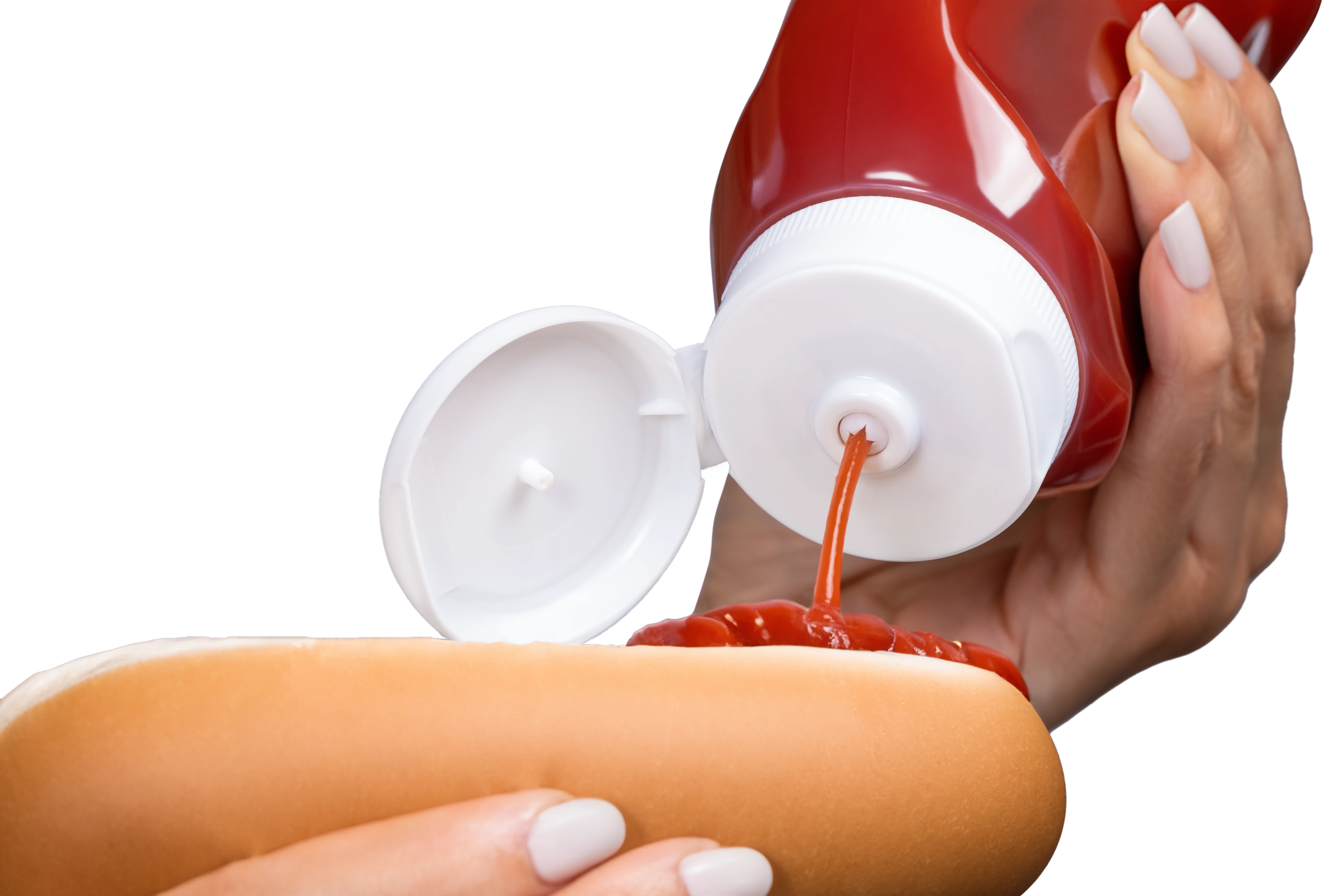 Valve dispensing ketchup on hot dog