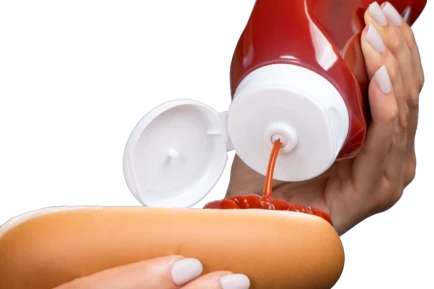 Valve dispensing ketchup on hot dog